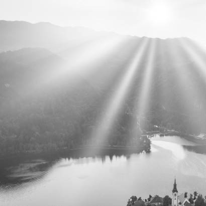 Bled Lake with Pilgrimage Church of the Assumption of Maria at sunrise. Aerial view.